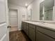 Bathroom with double sinks, shaker cabinets, and luxury vinyl plank flooring at 109 Rosefield Ct, Summerville, SC 29485
