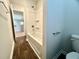 This bathroom features a shower-tub combo with white walls and fixtures, plus wood-look flooring at 109 Rosefield Ct, Summerville, SC 29485
