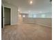 A bright and open carpeted bonus room space with a half wall and views to the home's windows at 109 Rosefield Ct, Summerville, SC 29485