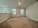 A spacious bonus room with neutral carpet, natural light from multiple windows, and classic paint at 109 Rosefield Ct, Summerville, SC 29485