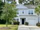 Charming two-story home featuring a well-maintained lawn, attached garage, and classic light-grey siding at 109 Rosefield Ct, Summerville, SC 29485