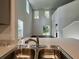 Bright kitchen with stainless sink, and an open view of the stairway and a large windowed wall at 109 Rosefield Ct, Summerville, SC 29485