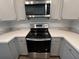 Stainless steel range and microwave are framed by shaker cabinets in this modern kitchen at 109 Rosefield Ct, Summerville, SC 29485