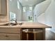Bright kitchen with stainless sink, dishwasher, and an open view of the stairway at 109 Rosefield Ct, Summerville, SC 29485