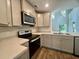 Bright kitchen with stainless appliances, light gray cabinets, and quartz countertops at 109 Rosefield Ct, Summerville, SC 29485