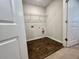 This laundry room has hard surface floors, utility connections, and a wire shelf above at 109 Rosefield Ct, Summerville, SC 29485