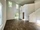 Spacious living room with high ceilings, modern flooring, and plenty of natural light from large windows at 109 Rosefield Ct, Summerville, SC 29485