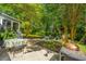 Expansive backyard featuring a patio, fire pit, and mature trees, creating a serene and inviting outdoor space at 1098 Blue Marlin Dr, Charleston, SC 29412