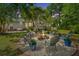 Backyard patio space featuring an outdoor fire pit with Adirondack chairs creating a space for entertaining and relaxing at 1098 Blue Marlin Dr, Charleston, SC 29412