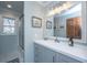 Well-lit bathroom with a gray vanity, white countertop, and framed mirror at 1098 Blue Marlin Dr, Charleston, SC 29412