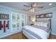 Stylish bedroom with plantation shutters, a ceiling fan, and hardwood floors at 1098 Blue Marlin Dr, Charleston, SC 29412