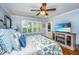 Bright bedroom with plantation shutters and a TV with an entertainment center at 1098 Blue Marlin Dr, Charleston, SC 29412