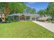 Charming single-story home with a lush front lawn and a boat parked in the driveway at 1098 Blue Marlin Dr, Charleston, SC 29412