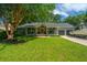 Inviting single-story home with a boat parked in the driveway and a welcoming front porch at 1098 Blue Marlin Dr, Charleston, SC 29412