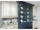 The kitchen features granite countertops, white cabinets, and a dark blue china cabinet at 1098 Blue Marlin Dr, Charleston, SC 29412
