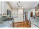 Open kitchen with granite countertops, stainless steel appliances, and hardwood floors is well lit at 1098 Blue Marlin Dr, Charleston, SC 29412