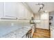 Modern kitchen features granite countertops, custom cabinets, stainless steel appliances, and hardwood floors at 1098 Blue Marlin Dr, Charleston, SC 29412