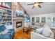 Spacious living room with a brick fireplace, built-in shelves, and ample natural light at 1098 Blue Marlin Dr, Charleston, SC 29412