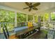 Inviting screened porch with ample seating and natural light, ideal for enjoying the outdoors in comfort at 1098 Blue Marlin Dr, Charleston, SC 29412
