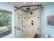 Modern bathroom shower with rainfall shower head, glass door, and tiled walls at 1098 Blue Marlin Dr, Charleston, SC 29412