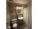 A vintage-style bathroom featuring a classic sink, patterned wallpaper, and unique lighting fixtures at 1139 Belvedere Dr, Hanahan, SC 29410
