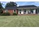 The front yard of a well-maintained single-story home, showcasing its classic brick and siding exterior at 1139 Belvedere Dr, Hanahan, SC 29410