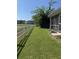 Exterior view of the backyard features green lawn, a white fence, and a screened-in porch at 120 Townsend Way, Summerville, SC 29483