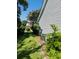 Side view of the home with grey siding, lush landscaping, and a neatly maintained lawn at 120 Townsend Way, Summerville, SC 29483