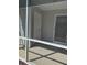 This covered porch features a neutral-toned floor, white trim, and provides a view of the backyard at 120 Townsend Way, Summerville, SC 29483