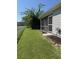 Exterior view of the backyard features green lawn, a white fence, and a screened-in porch at 120 Townsend Way, Summerville, SC 29483