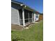 View of the porch, grey siding, and lush landscaping at 120 Townsend Way, Summerville, SC 29483