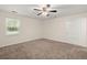 A carpeted bedroom features a ceiling fan and a window providing ample natural light at 122 Lawrence Rd, Moncks Corner, SC 29461