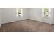A carpeted bedroom features two windows, providing ample natural light at 122 Lawrence Rd, Moncks Corner, SC 29461