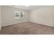 A carpeted bedroom features a large window providing ample natural light at 122 Lawrence Rd, Moncks Corner, SC 29461