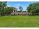 Long view of a brick home with a spacious lawn and mature trees at 122 Lawrence Rd, Moncks Corner, SC 29461