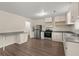 A bright kitchen with stainless steel appliances, wood-look flooring and neutral cabinets at 122 Lawrence Rd, Moncks Corner, SC 29461