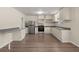 Open kitchen with stainless steel appliances, wood-look flooring and neutral cabinets at 122 Lawrence Rd, Moncks Corner, SC 29461