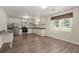 Open-concept kitchen and dining area with modern appliances, white cabinets, and a large window for natural light at 122 Lawrence Rd, Moncks Corner, SC 29461