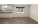 Bright kitchen features wood-look flooring, neutral cabinets, and a window overlooking the backyard at 122 Lawrence Rd, Moncks Corner, SC 29461