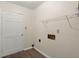 Functional laundry area with wood-look floors, a white door, shelving, and hookups for a washer and dryer at 122 Lawrence Rd, Moncks Corner, SC 29461