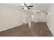 Bright living room features wood-look floors, light walls, a ceiling fan, and multiple doorways to adjacent rooms at 122 Lawrence Rd, Moncks Corner, SC 29461