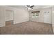 Inviting living room features plush carpeting, paneled walls, a window with valance, and entry door with side lights at 122 Lawrence Rd, Moncks Corner, SC 29461