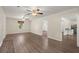 Open living room with light walls, wood-look floors, ceiling fans, views to other rooms, and natural light at 122 Lawrence Rd, Moncks Corner, SC 29461