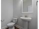 Powder room featuring pedestal sink, wood floors, and neutral paint at 124 Cantona Dr, Summerville, SC 29483
