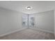 Neutral bedroom boasts a large window, plush carpet, and fresh white paint at 124 Cantona Dr, Summerville, SC 29483