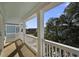 Spacious porch with white railings overlooking green foliage and neighborhood at 124 Cantona Dr, Summerville, SC 29483