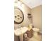 Cozy bathroom with pedestal sink, round mirror, and woven basket accents at 136 Blue Jasmine Ln, Summerville, SC 29483