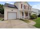 A well-maintained home with vinyl siding, red shutters, and an attached garage and walkway to the front porch at 136 Blue Jasmine Ln, Summerville, SC 29483
