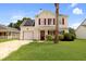 Charming two-story home with vinyl siding, red shutters, front yard landscaping, and solar panels at 136 Blue Jasmine Ln, Summerville, SC 29483