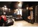 Basement living room featuring black walls and tile flooring at 136 Blue Jasmine Ln, Summerville, SC 29483